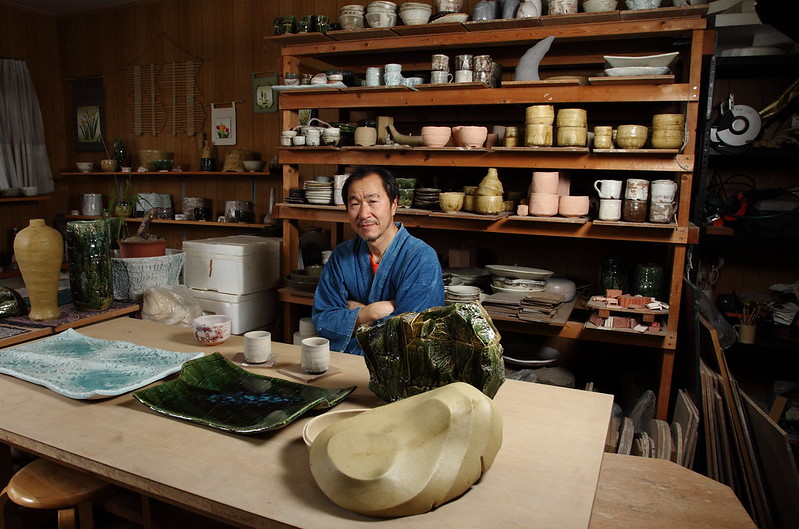 Japanese pottery master posing in workshop